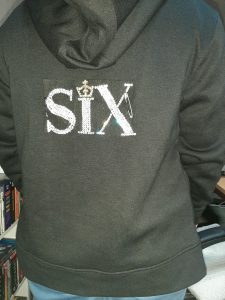 Six logo pinned onto hoodie