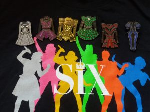 Six merch- t-shirt and costume pins
